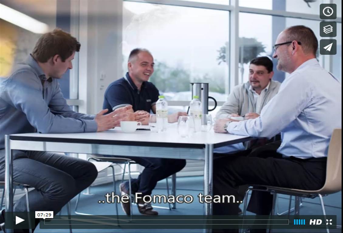 A still taken from Fomaco's corporate video showing four Fomaco workers sat around a table chatting.